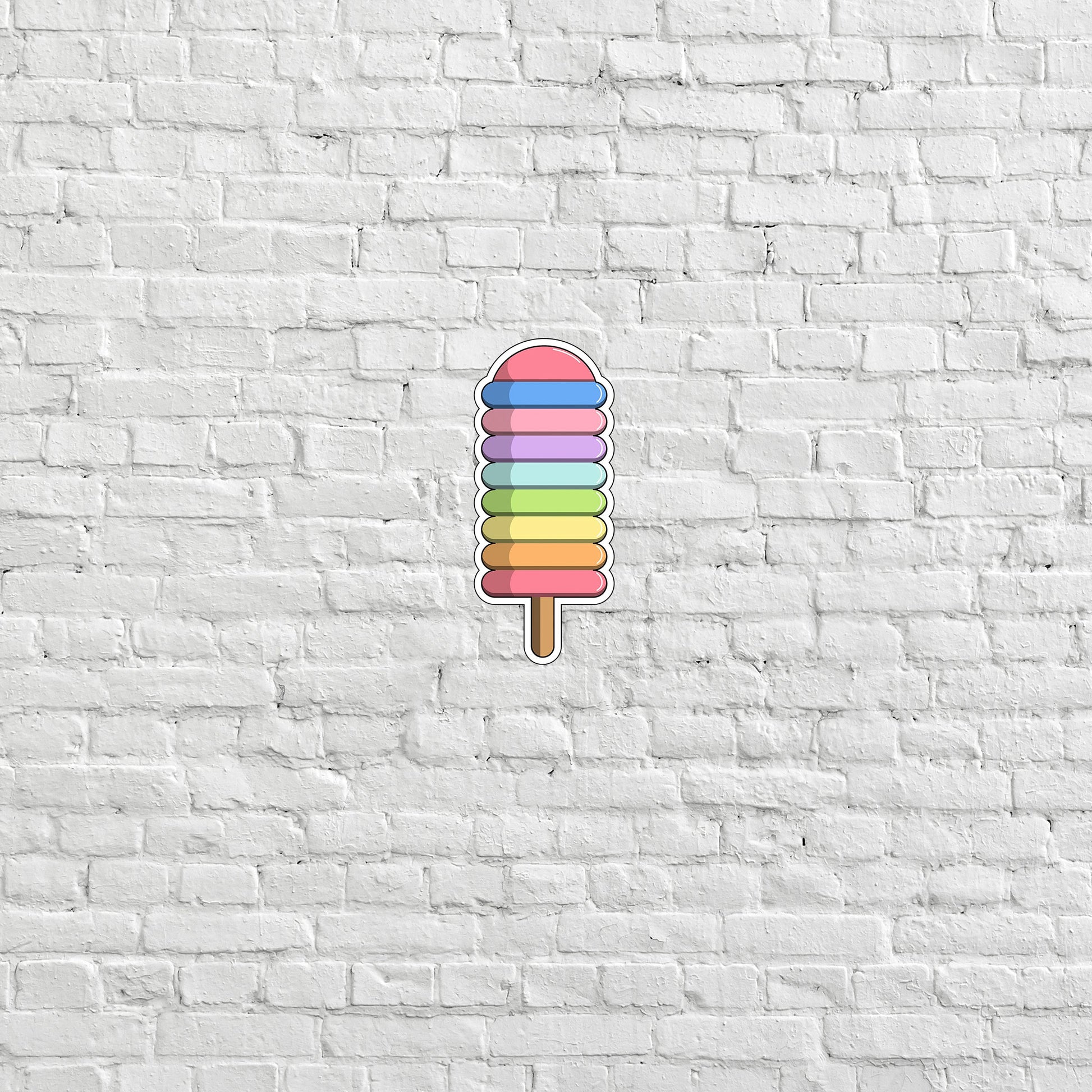 a colorful popsicle on a white brick wall