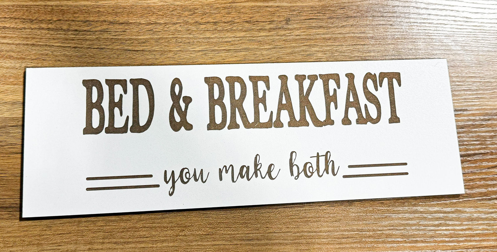 a bed and breakfast sign on a wooden table