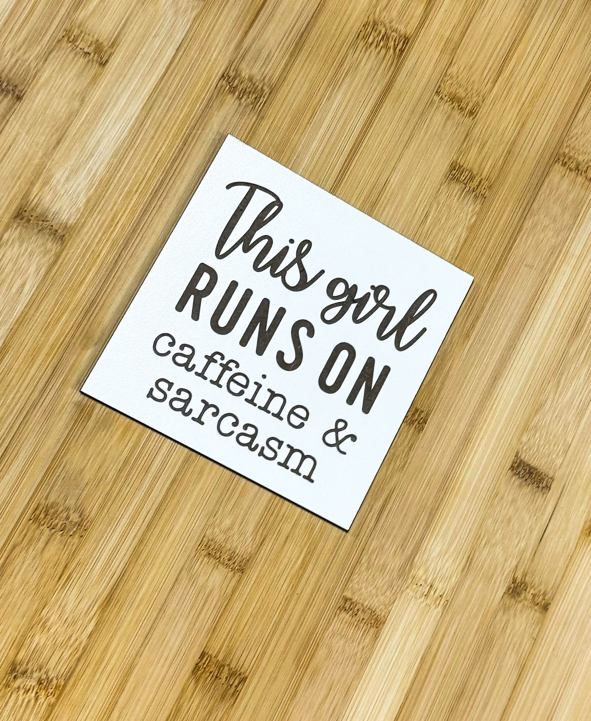 a close up of a wooden table with a sign on it