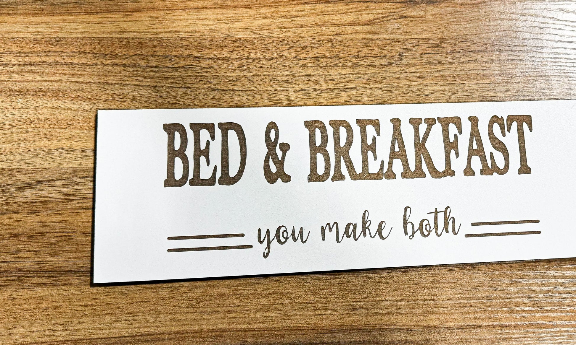 a bed and breakfast sign on a wooden table