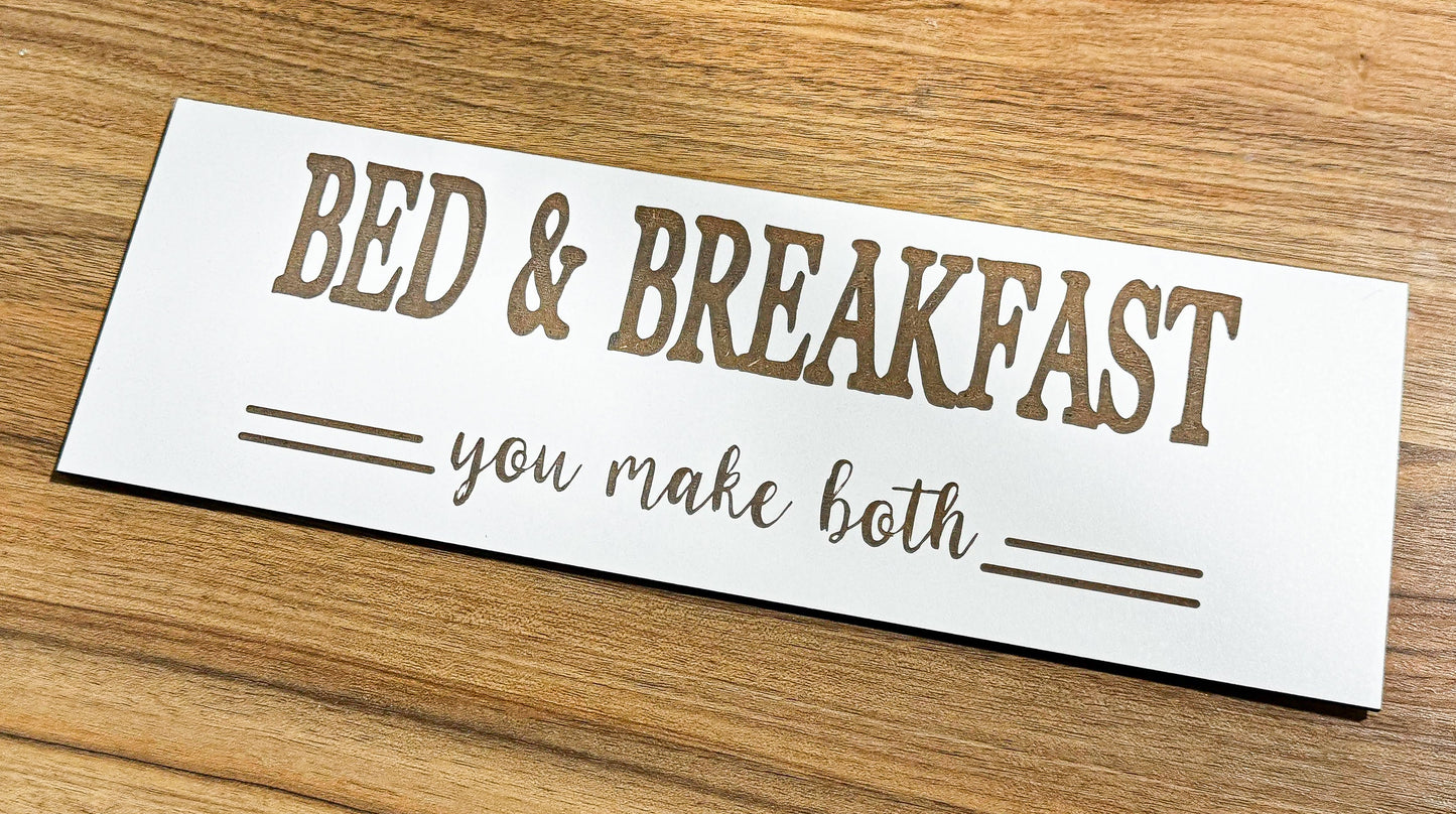 a bed and breakfast sign on a wooden table