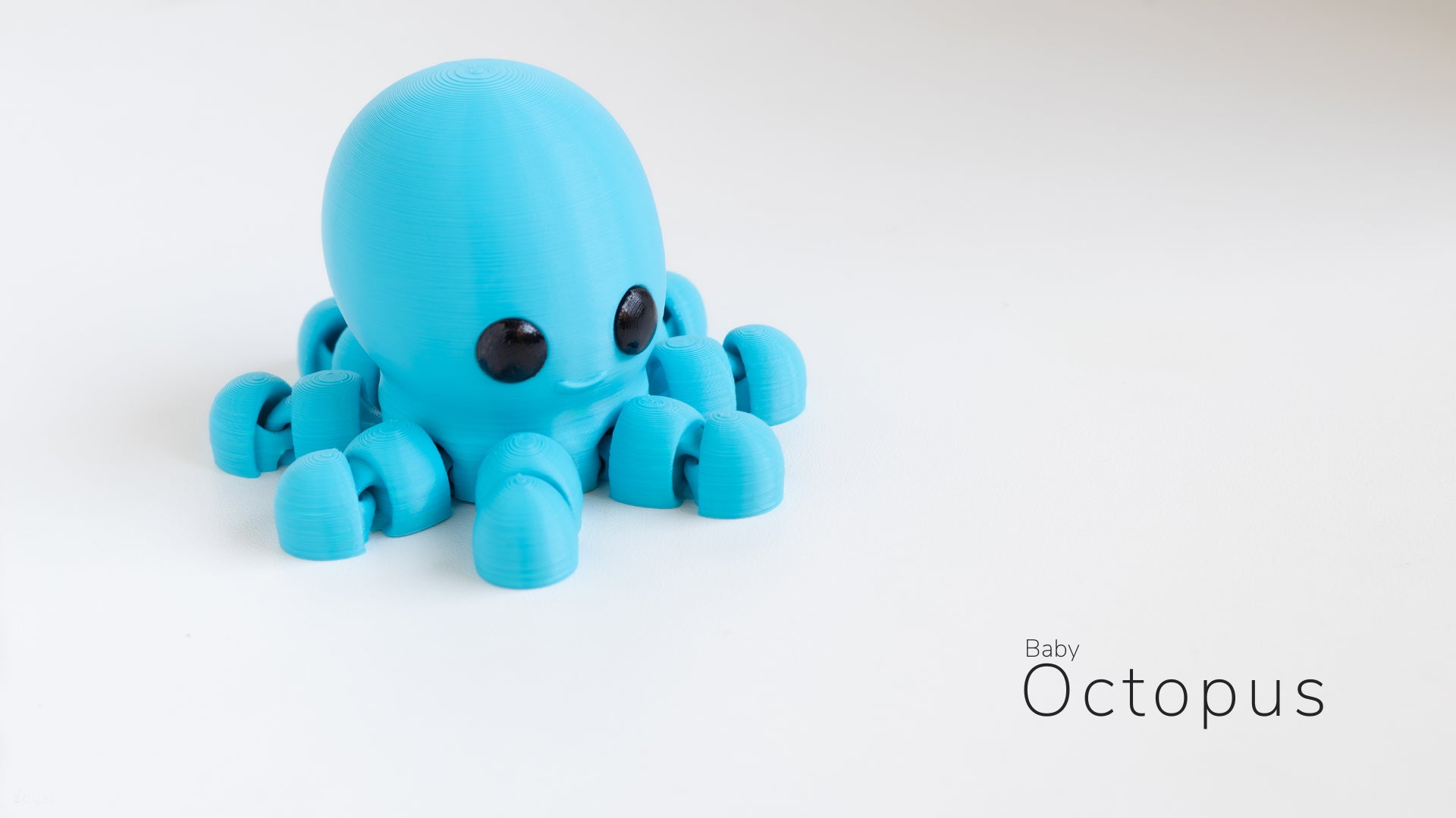 a blue octopus toy sitting on top of a white table