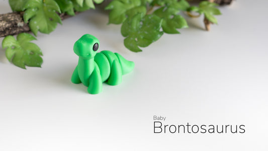 a green toy sitting on top of a white table