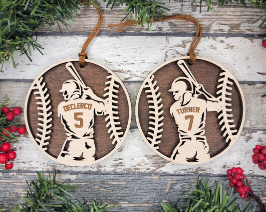 two baseball ornament hanging on a wooden background