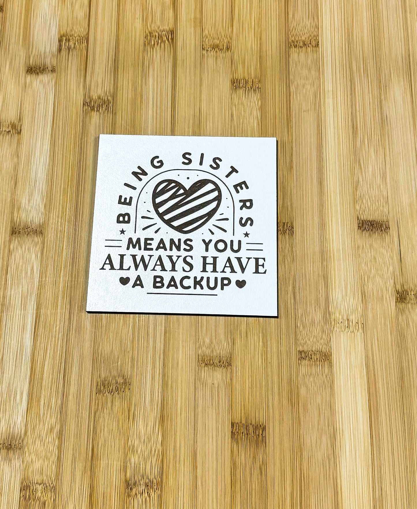 a sticker that says being sister means you always have a backup