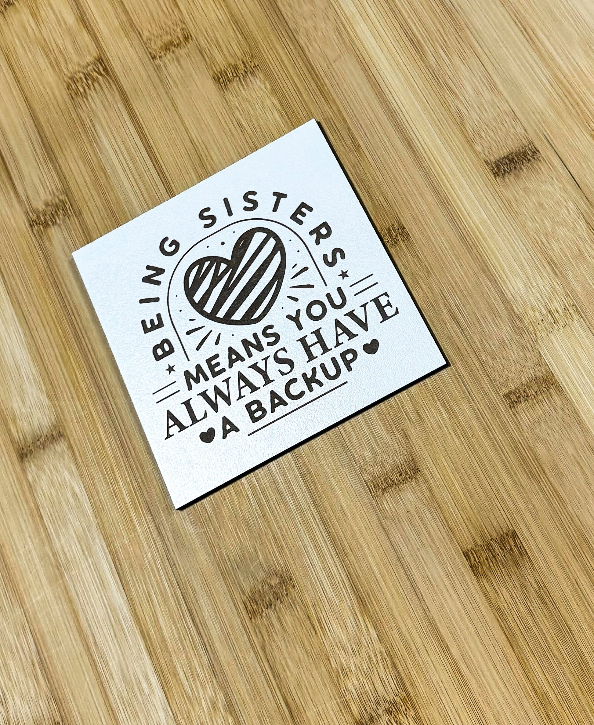 a sticker on a wooden surface that says, being sisters means you always have