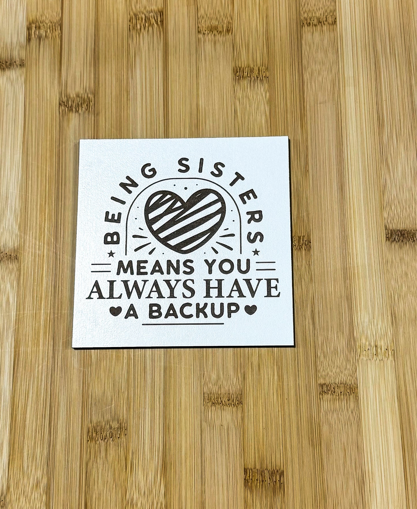 a sticker that says being sister means you always have a backup